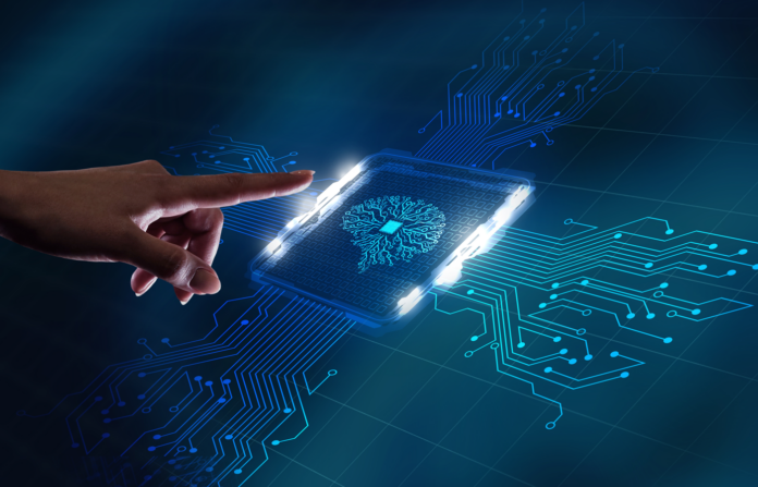 Hand interacting with a virtual chip with a digital brain logo embedded on a circuit grid.