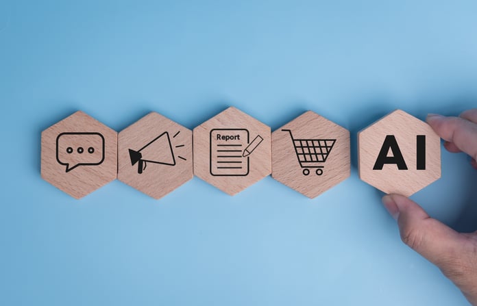 AI In CRM: How AI is Reshaping Customer Experiences Hand placing an wooden AI-inscripted tile, to a series of tiles with inscripted CRM features.
