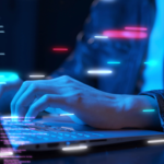 IT professional working on a laptop with floating virtual blocks of code.