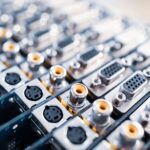 Close-up blurry metal sockets on a computer video board. Concept for the production of computer televisions and audio speakers