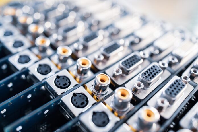 Close-up blurry metal sockets on a computer video board. Concept for the production of computer televisions and audio speakers