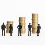 Scaled figures of people on background of stacked coins.