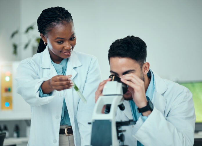 Scientist, teamwork and microscope, plant research and natural study, medicine and growth check in .