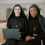 Two nuns with laptop.