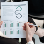 Woman holding a pencil while reading a report.