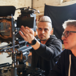 Professional videographer and film director working on a video equipment.