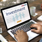 Person using a laptop while browsing on an investment-related website.