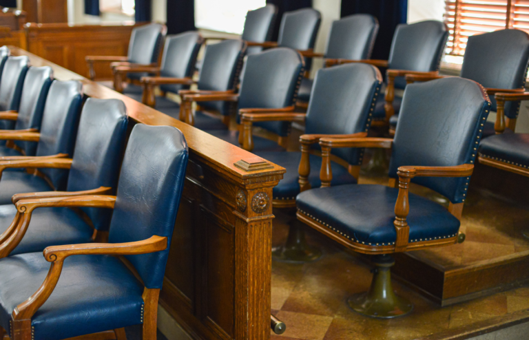 Empty jury box with leather seats.