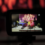 Influencer with pink hair showing a notebook to the camera while on stream.