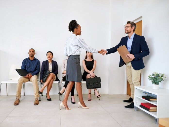 Group of people waiting to interview for a job.