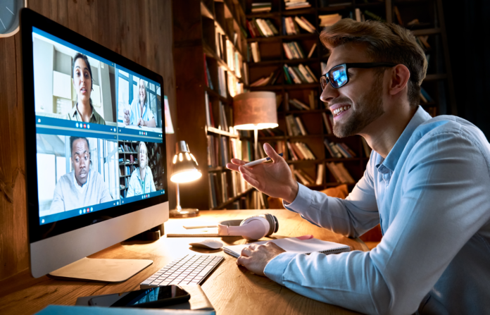 Businessman having an virtual conference meeting in a study room.