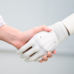 Woman shaking hands with a robot.