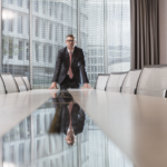 An executive standing on a conference table.