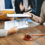 Business people and lawyers discussing contract papers sitting at the table.