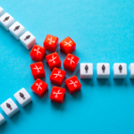 White dice with person icon and red dice with scissors icons on a blue background.