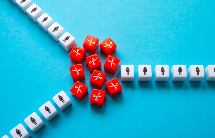 White dice with person icon and red dice with scissors icons on a blue background.