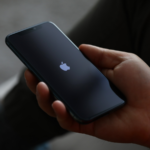Man holding an Apple iPhone.