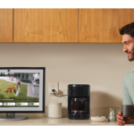 Man watching a video while having coffee.