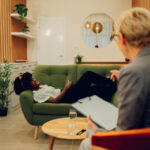 A woman lying down on a sofa.