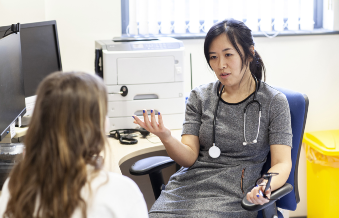 Doctor discussing with patient in a medical office.