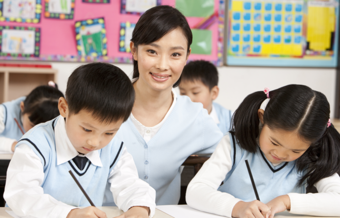 Teacher assisting students in class.