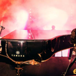 Paul McCartney playing on a piano.
