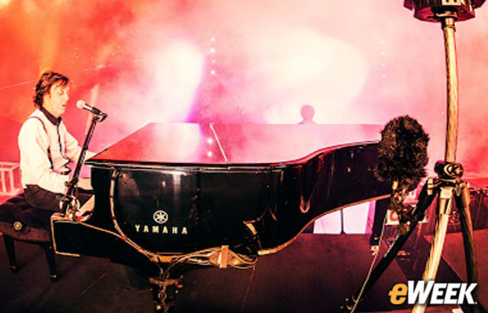 Paul McCartney playing on a piano.