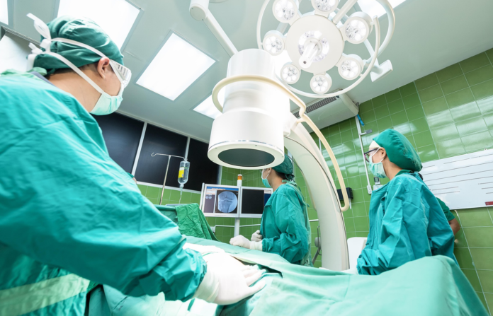 Doctors and medical professionals in an operating room.