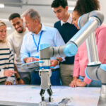 A group of engineering students listening to their professor.