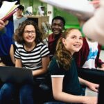 Group of students learning in classroom.