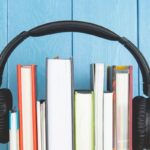 headphone and books on blue background.