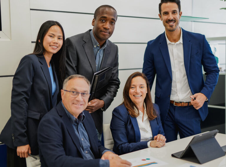 A group of business people gathering inside an office.