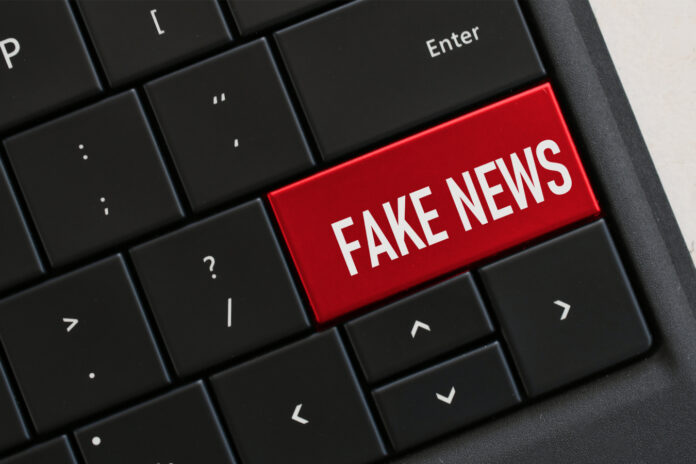 A keyboard with the keycap replaced with the word Fake News in red background.