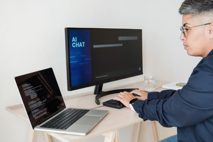 Programmer using artificial intelligence for software development inside office.