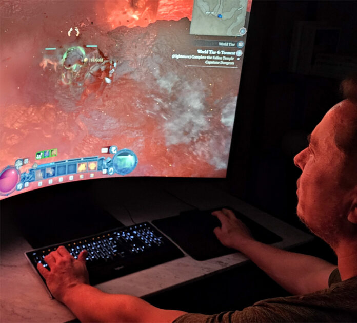 Elon Musk playing Diablo in a desktop computer.