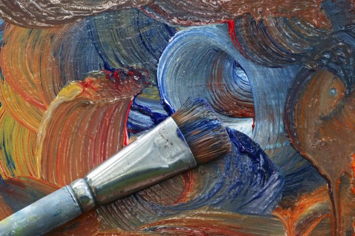 Stock photo of a paintbrush on a painting.