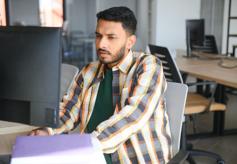 Happy indian male student at the university
