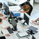 Four employees working hard inside the office.